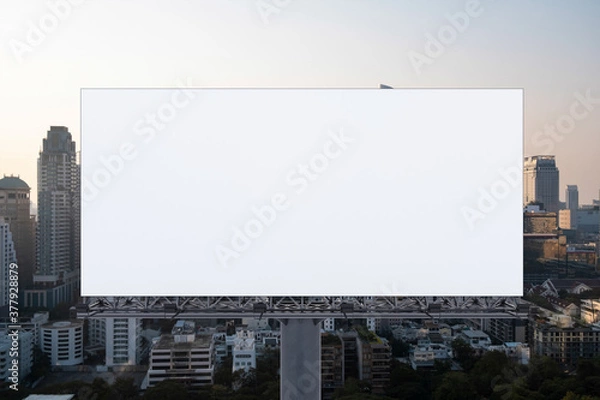 Fototapeta Blank white road billboard with Bangkok cityscape background at sunset. Street advertising poster, mock up, 3D rendering. Front view. The concept of marketing communication to promote or sell idea.