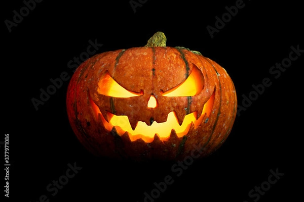 Obraz halloween pumpkin with glowing eyes and mouth isolated on black background closeup