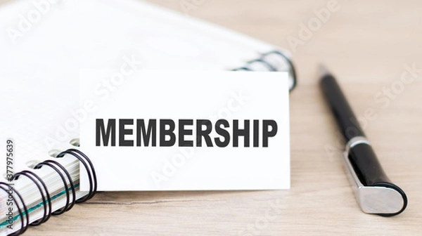 Fototapeta membership. text on a card next to a notebook and a pen on the table