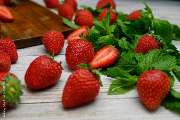 Obraz strawberries on a white table with mint sprigs