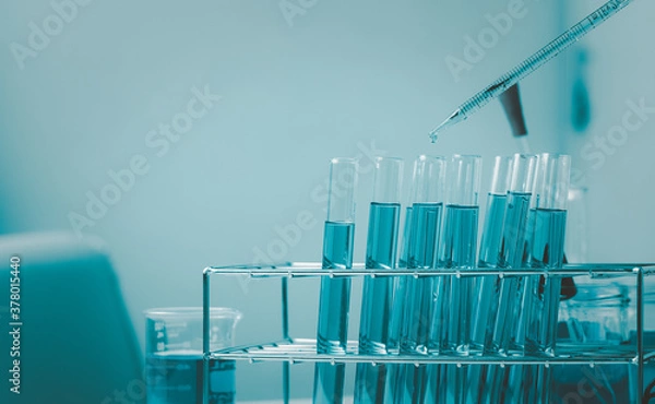 Fototapeta Pipette dropping a sample into a test tube and science experiments ,Laboratory glassware containing chemical liquid,
