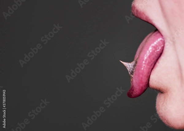 Obraz Tongue out, spikes on a tongue, close up