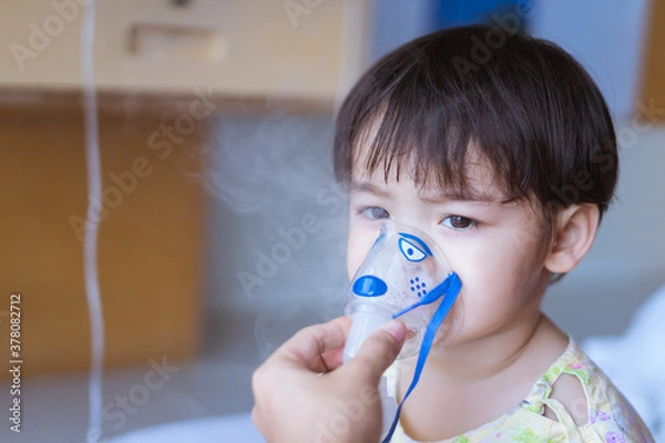 Fototapeta Little Asian boy under anesthesia with an oxygen mask in hospital.