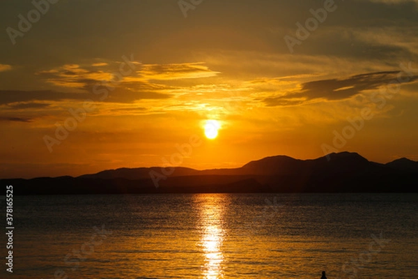 Fototapeta Sunset in Bardolino on Lake Garda with mountains in the background