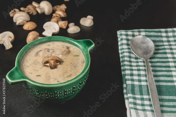 Obraz Homemade mushroom cream soup. Served on a dark background. Close-up view.