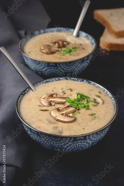 Obraz Homemade mushroom cream soup. Served on a dark background. Close-up.