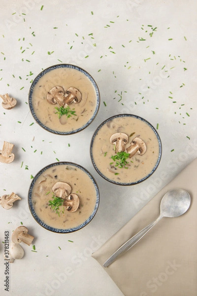 Obraz Homemade mushroom cream soup. Served on a white background. Top view.