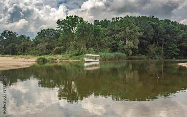 Fototapeta Beautiful shot of a kimchia river with cloudy sky in the background