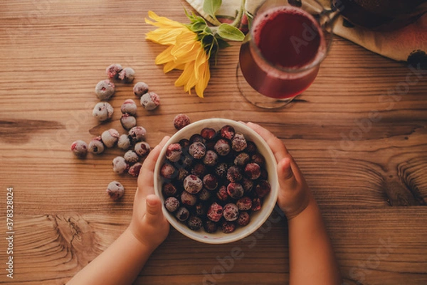 Fototapeta Still life. Frozen cherries and cherry juice on wooden background