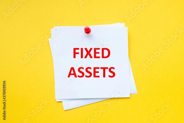 Fototapeta Fixed assets. Word on white sticker with yellow background