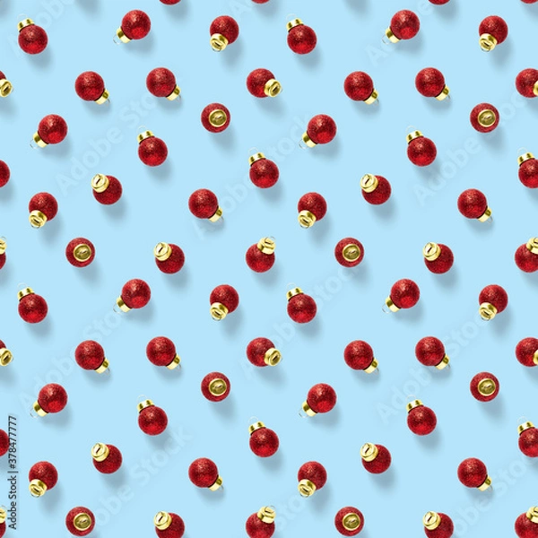 Fototapeta Seamless pattern with red Christmas decorations on blue background. Christmas abstract background made from balls. Christmas red ornaments Seamless pattern.