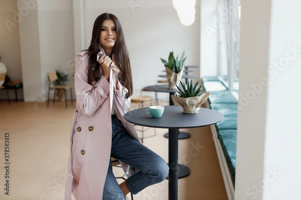Fototapeta beautiful girl in a coffee shop with a cup of coffee