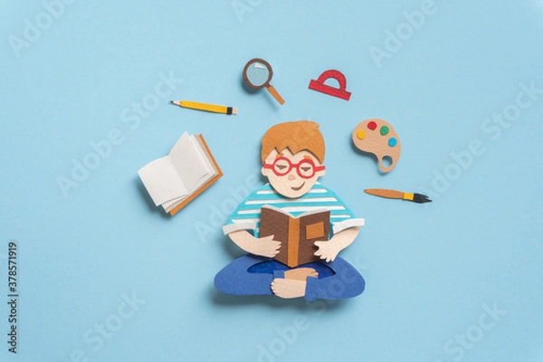 Fototapeta Smart schoolboy sitting in lotus pose with book. Illustration about education from paper on blue