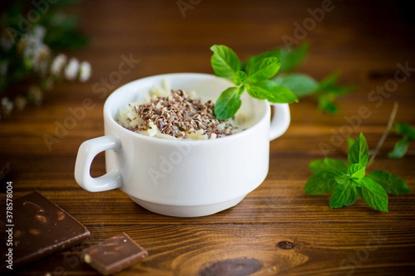 Fototapeta sweet noodles with milk and grated chocolate in a bowl