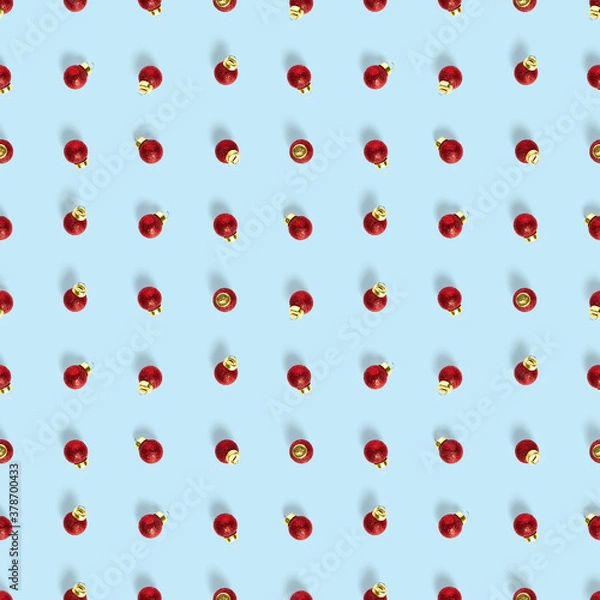 Fototapeta Seamless pattern with red Christmas decorations on blue background. Christmas abstract background made from balls. Christmas red ornaments Seamless pattern.