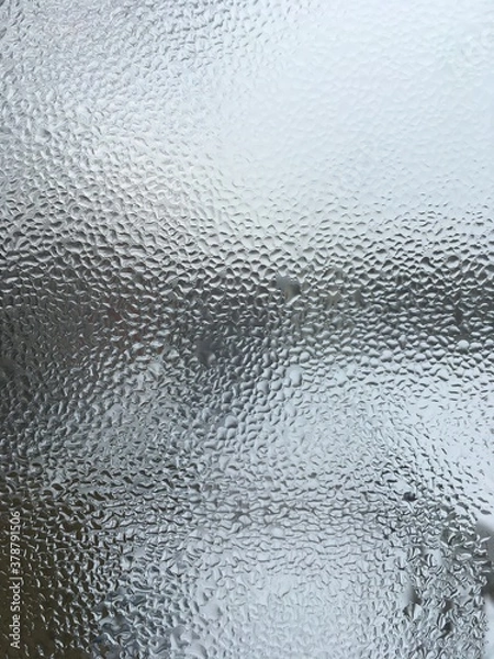 Obraz view from the window wet glass covered with wet flowing water, snow melts