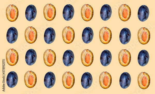 Fototapeta Pattern with blue plums on a beige background.