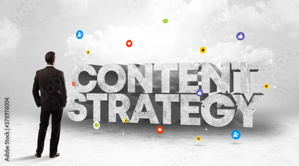 Fototapeta Young businessman standing in front of CONTENT STRATEGY inscription, social media concept