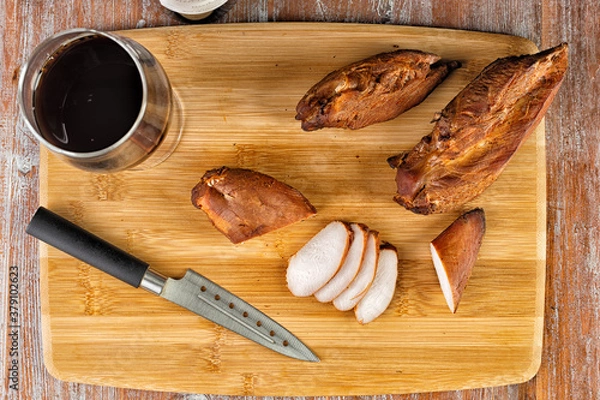 Fototapeta smoked meat lies on the table with herbs and sauce