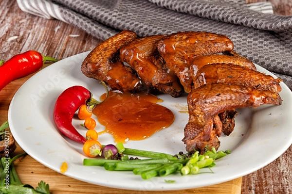 Fototapeta Composition with smoked chicken wings on the table