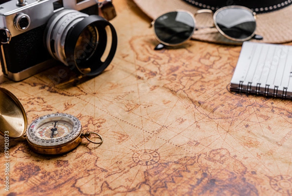 Obraz Vintage Compass and camera on map for travel planning