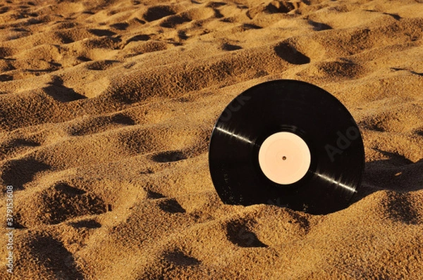 Obraz Vinyl record disk on a sandy beach.