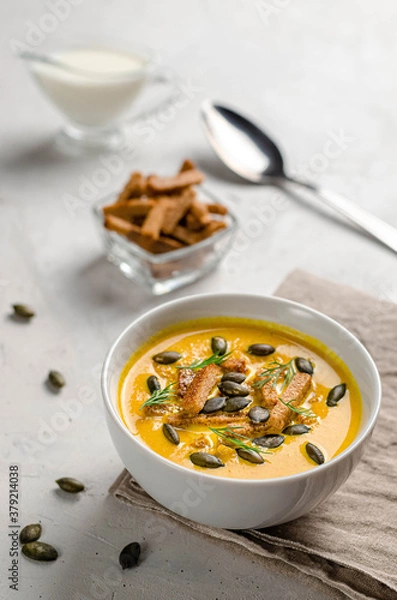 Obraz pumpkin puree soup with croutons and fried pumpkin seeds