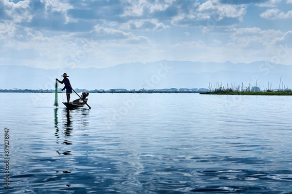 Fototapeta Inle Lake is in the Shan Hills of Myanmar. At its southwestern edge, Phaung Daw Oo Paya is a tiered pagoda with gilded Buddha statues. In the hills, near the market town of Indein, the stupas of Shwe 