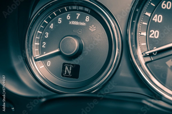 Fototapeta Closeup shot of symbol N show on speedometer in car with LCD display of odometer and trip calculator.