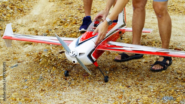 Fototapeta Red and white color RC plane on the ground for take off.