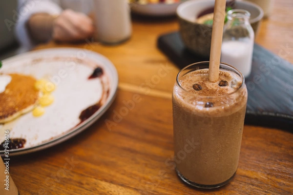 Fototapeta Glass of cold coffee with straw