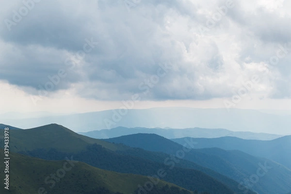 Fototapeta scenic clouds in beautiful mountains in summer day