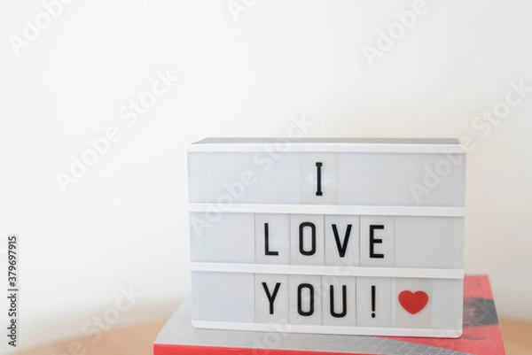 Fototapeta White lightbox with I love you message and a red heart. White background.