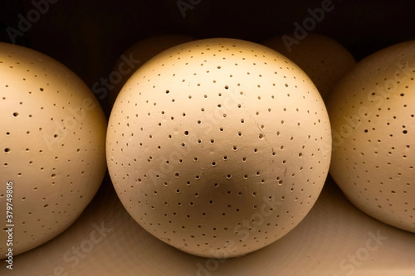 Fototapeta Mysterious balls with holes.