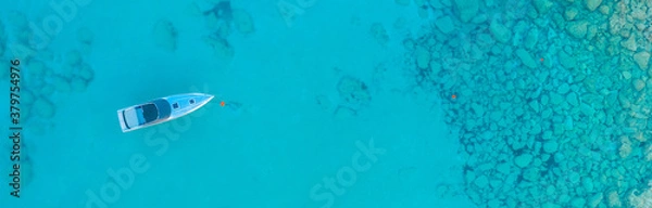 Obraz An aerial view of the beautiful Mediterranean Sea, where you can see the cracked rocky textured underwater corals and the clean turquoise water of Protaras, Cyprus,