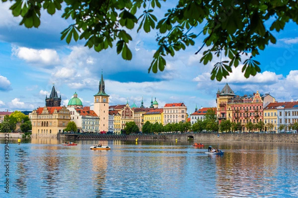 Fototapeta The landscape of the city of Prague view from the Vltava river on the ancient architecture of the city