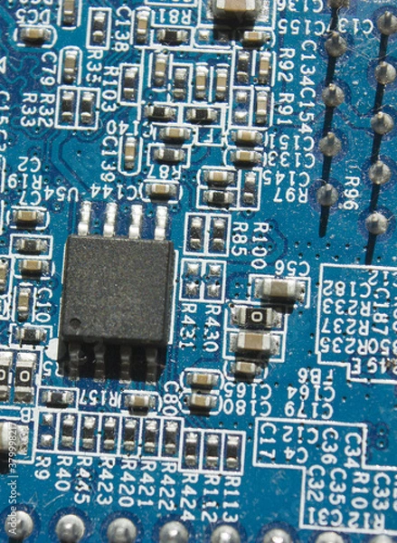 Obraz microchip and components on blue electronic pcb closeup