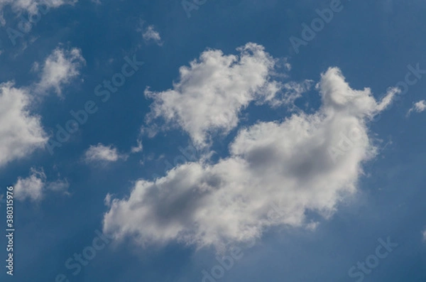 Fototapeta Fluffy clouds in a blue sky background and pattern