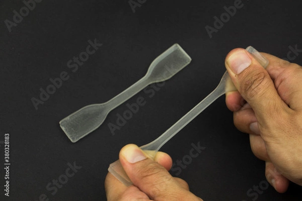 Fototapeta polydimethylsiloxane (pdms) polymer sample which is using in engineering experiments. it is a tensile test specimen to examine the strength of the material.