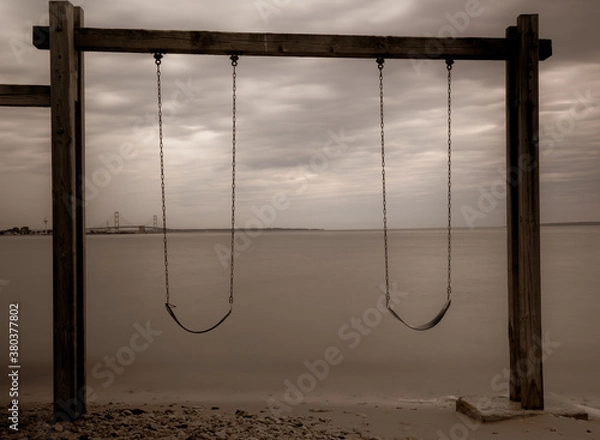 Obraz Cloudy Lake Huron and swing on the beach at dawn in summer Michigan
