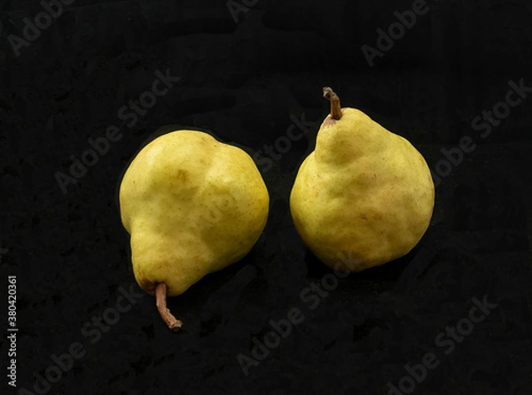 Obraz two yellow pears on black background