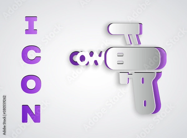 Fototapeta Paper cut Ray gun icon isolated on grey background. Laser weapon. Space blaster. Paper art style. Vector.