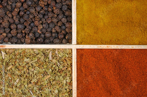 Obraz Four spices in a wooden square split jar