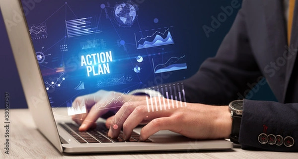 Fototapeta Businessman working on laptop with ACTION PLAN inscription, new business concept