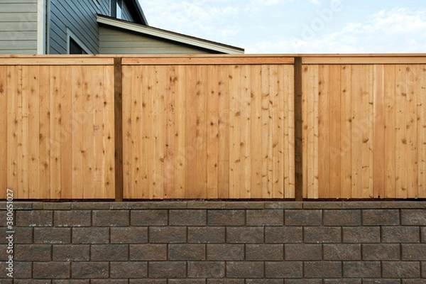Obraz Wood Fenceing over Stone Retaining Wall