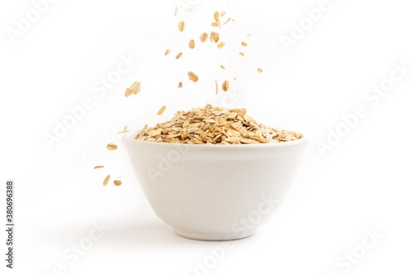 Obraz Front view of oat flakes on a ceramic bowl