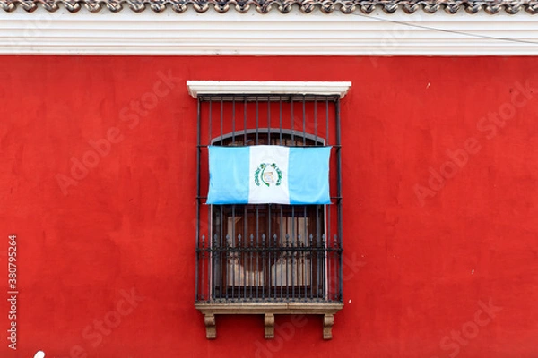 Obraz Guatemalan flag upside down on a window in antigua guatemala