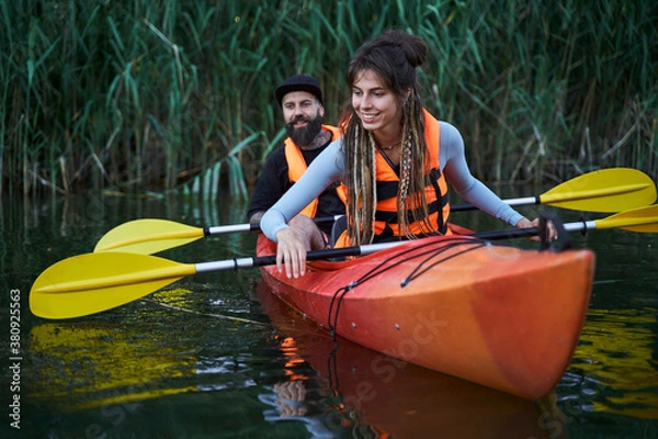 Obraz Happy family paddling kayak at evening