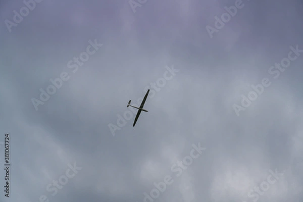Obraz a glider towed by a plane in cloudy sky