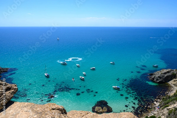 Obraz the yachts on the transparent blue water of a sea bay. The shadows of the ships and the boats lays on a sand bottom of the sea